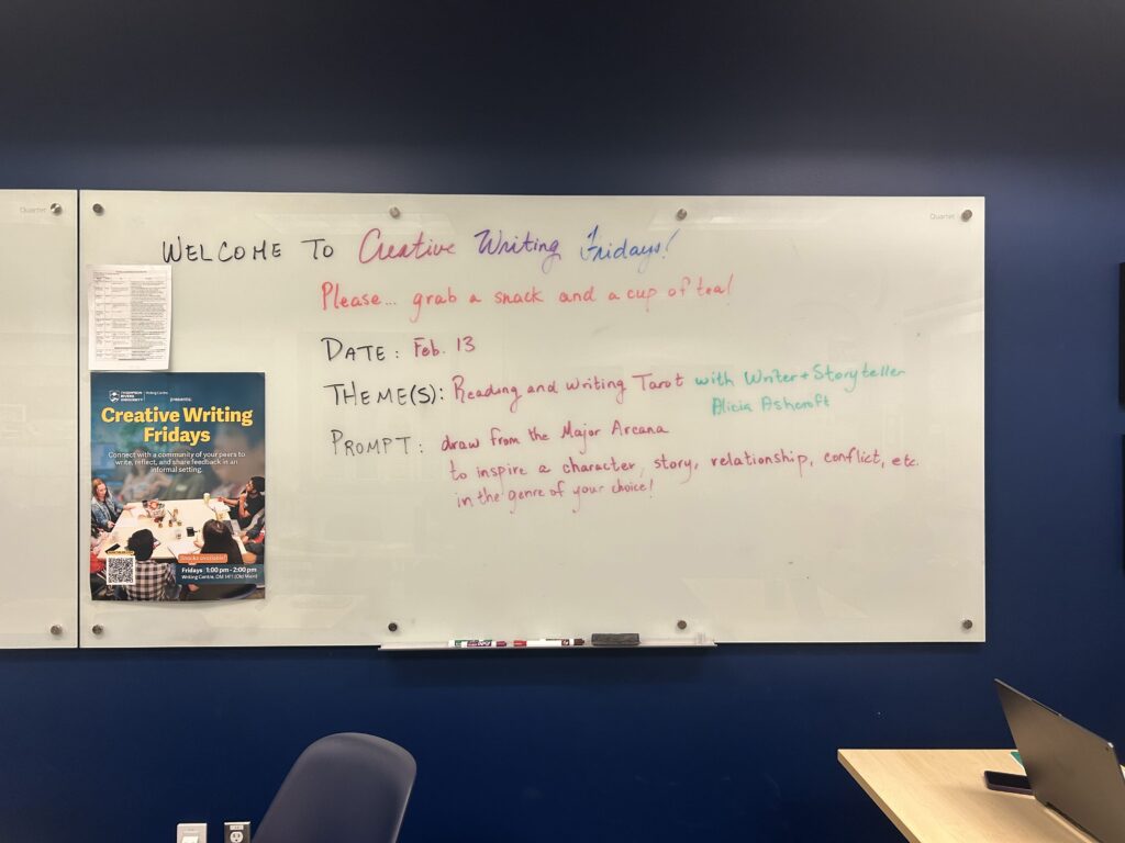 Image of a white board and poster for Creative Writing Fridays.
